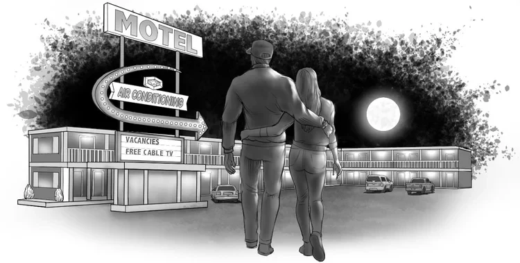 A couple standing together outside a roadside motel beneath a full moon